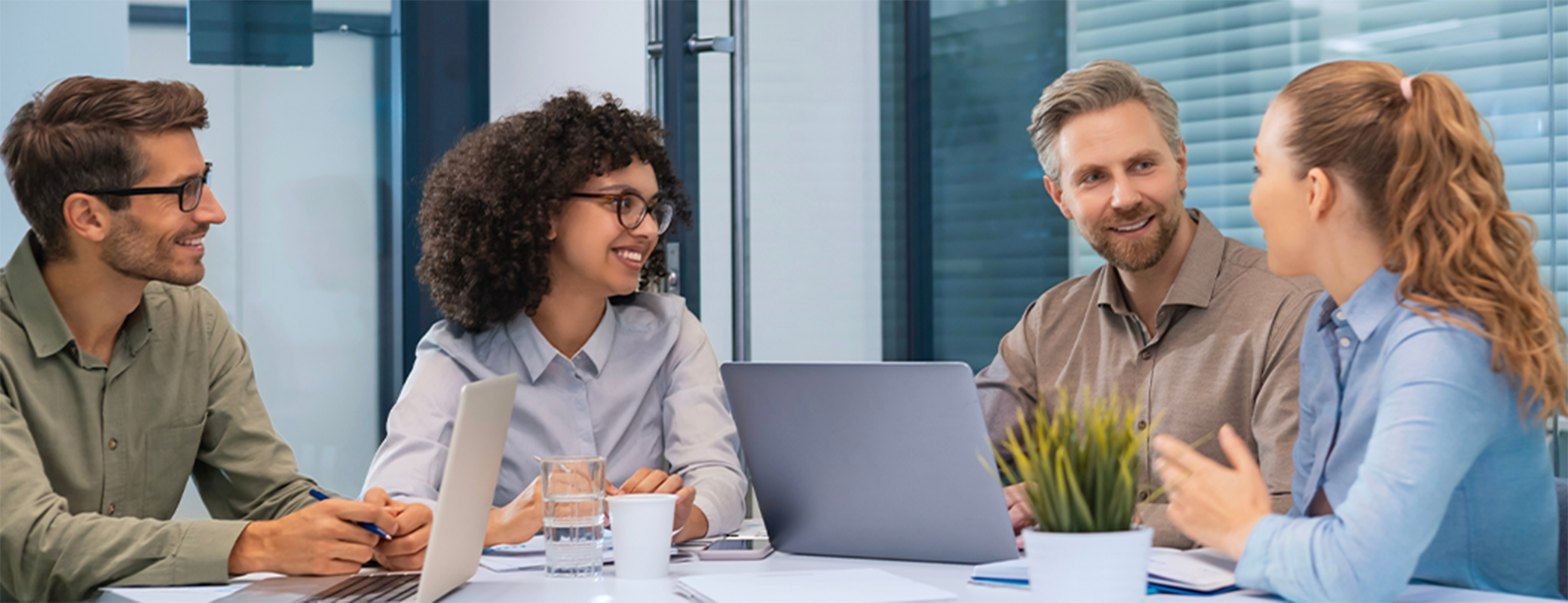 Image of adults talking at a meeting in a conference room